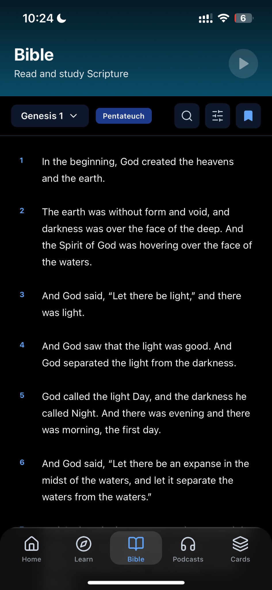 Bible reader showing Genesis